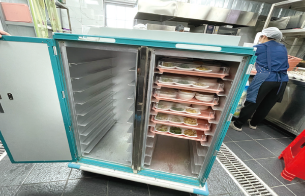 中午時分,廚師將飯菜放入航空級保溫餐車。